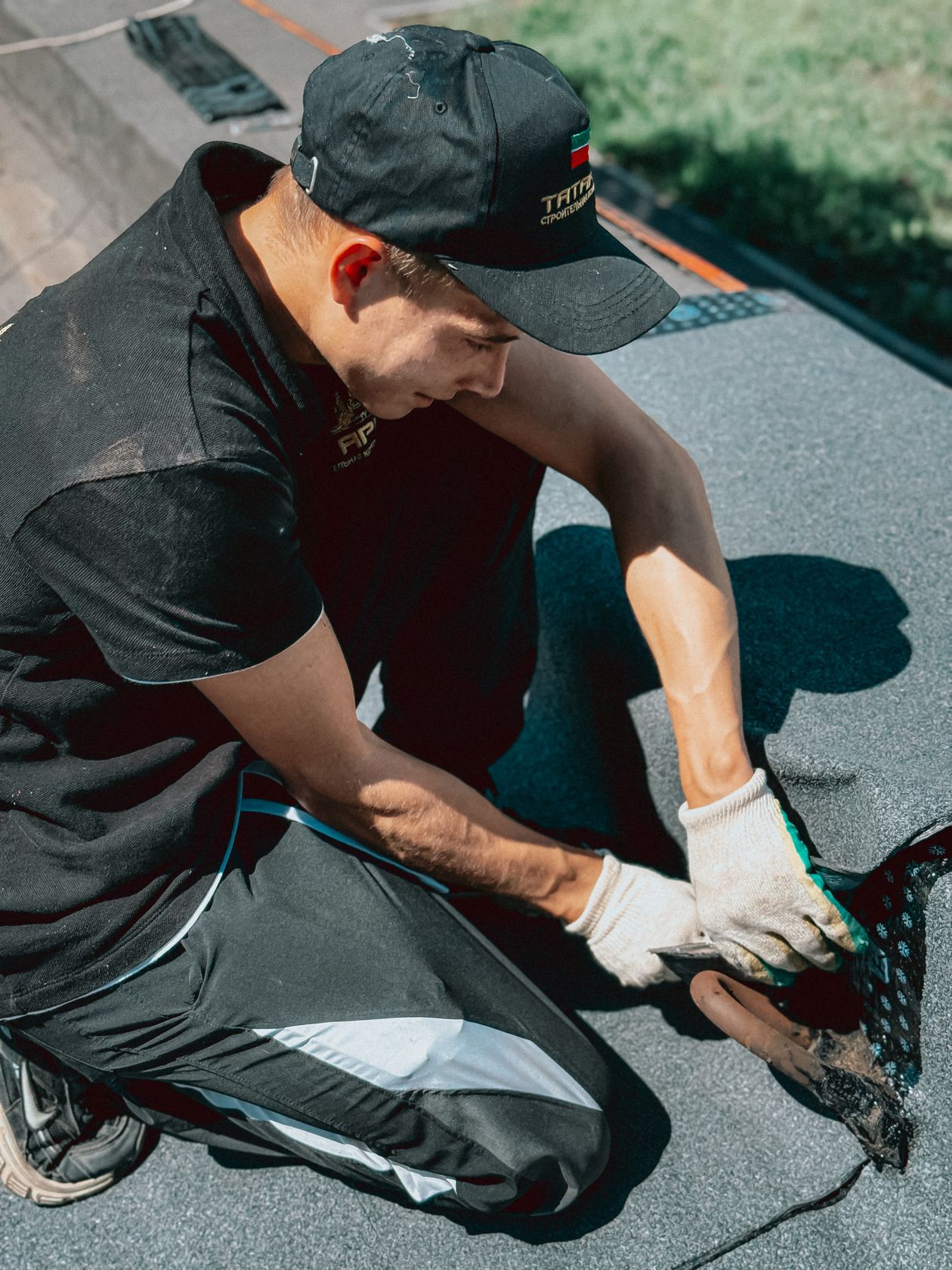 Roofer installing single-ply membrane on a flat roof