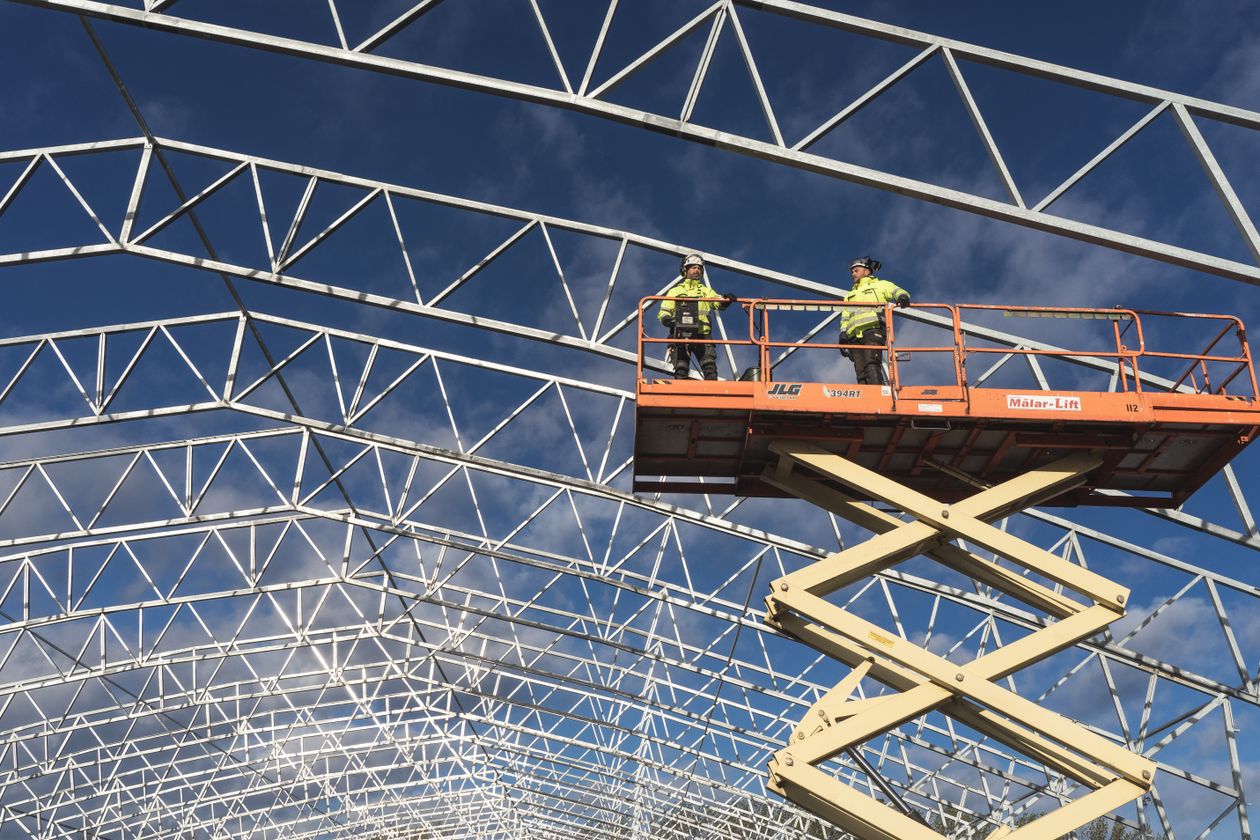 Crew working from a lift on a steel-frame building